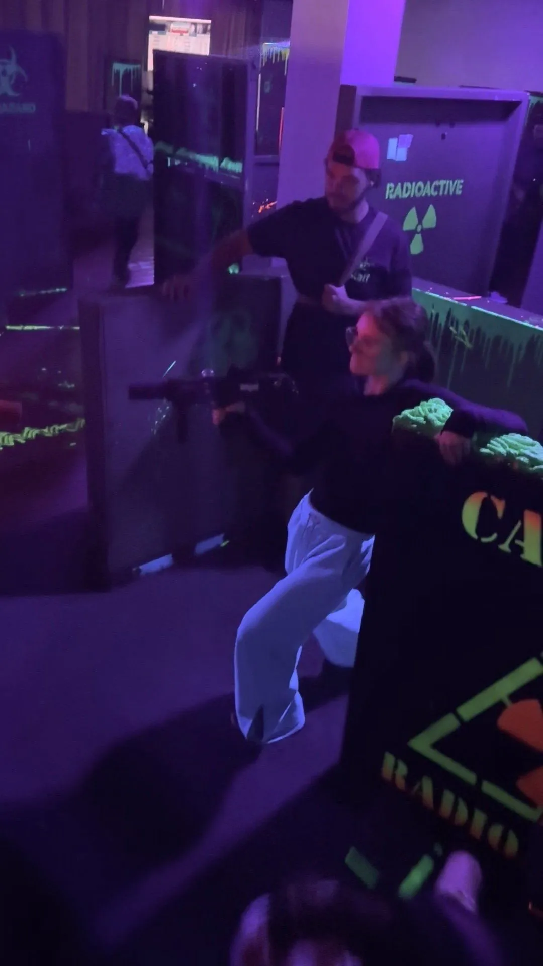 Squad using tactical laser taggers among radioactive arena obstacles